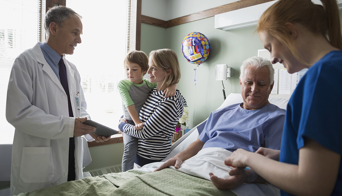 Doctor with digital tablet talking to family